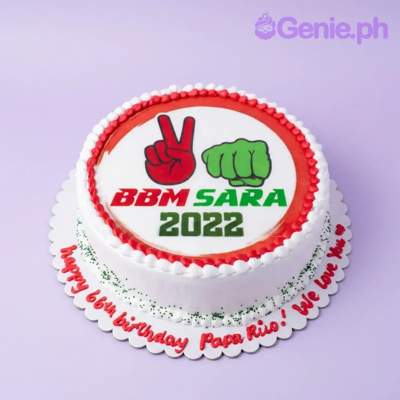 A white 1-tier round cake themed around BBM Sara 2022, featuring a campaign logo printout and red and white icing borders. A white 1-tier round cake themed around BBM Sara 2022, featuring a campaign logo printout and red and white icing borders.