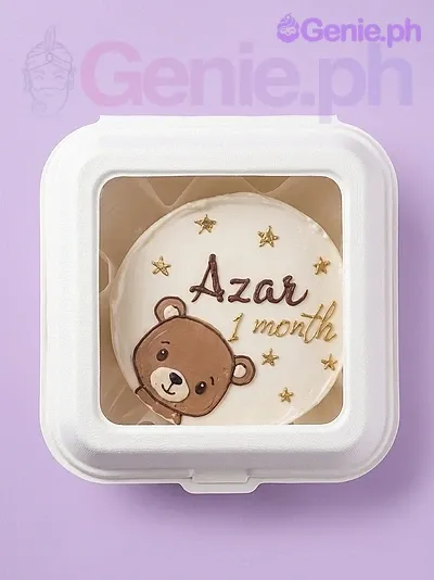A white, brown, and gold Bento cake themed around a bear, featuring a brown bear printout and gold stars with 'Azar 1 month' text. A white, brown, and gold Bento cake themed around a bear, featuring a brown bear printout and gold stars with 'Azar 1 month' text.