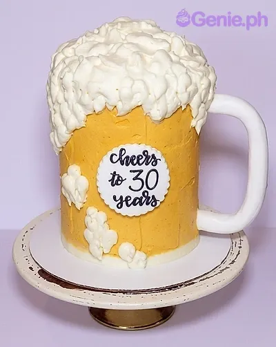 A yellow and white 1 Tier cake themed as a beer mug, featuring an edible handle, white icing foam, and 'Cheers to 30 years' text. A yellow and white 1 Tier cake themed as a beer mug, featuring an edible handle, white icing foam, and 'Cheers to 30 years' text.