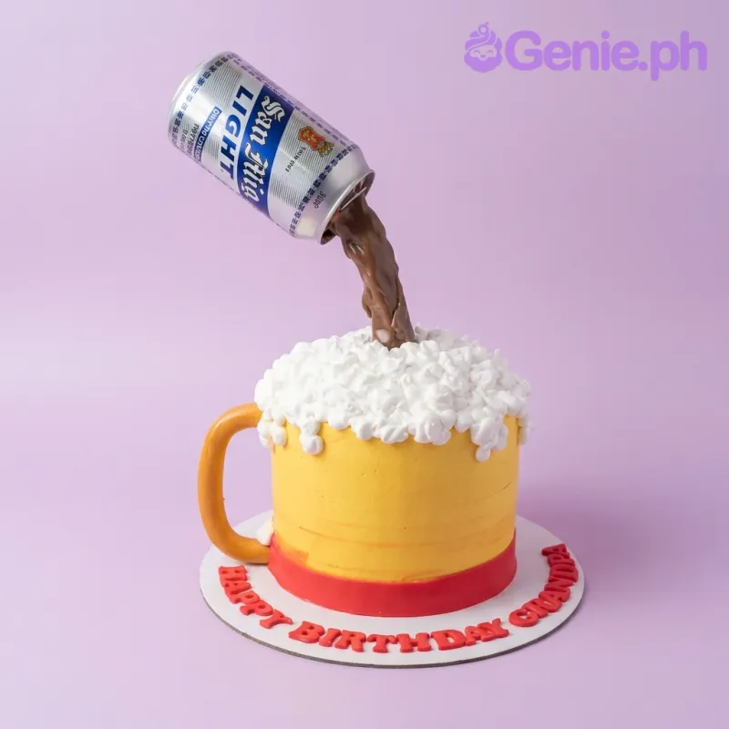 A yellow and white 1 Tier cake themed as a San Miguel Light Beer Mug, featuring a pouring beer can and white icing foam. A yellow and white 1 Tier cake themed as a San Miguel Light Beer Mug, featuring a pouring beer can and white icing foam.