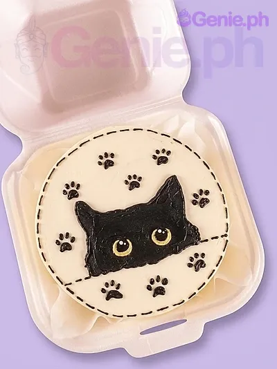 Bento cat cake design — bento soft icing cake in white — with black cat head, and cat paw prints Bento cat cake design — bento soft icing cake in white — with black cat head, and cat paw prints