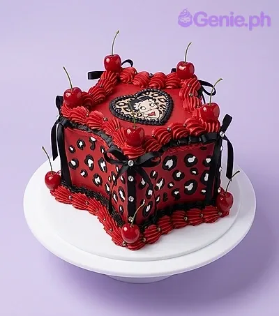 A red square Betty Boop cake with a heart topper, leopard print sides, and red cherries. A red square Betty Boop cake with a heart topper, leopard print sides, and red cherries.