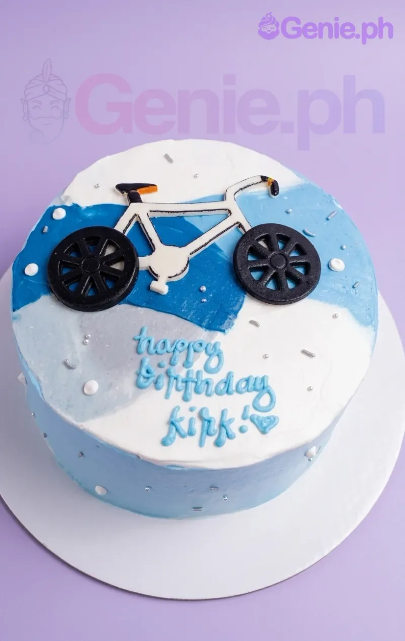 Bento cake with blue and white watercolor icing, a bicycle topper, and a Happy Birthday Kirk message. Bento cake with blue and white watercolor icing, a bicycle topper, and a Happy Birthday Kirk message.