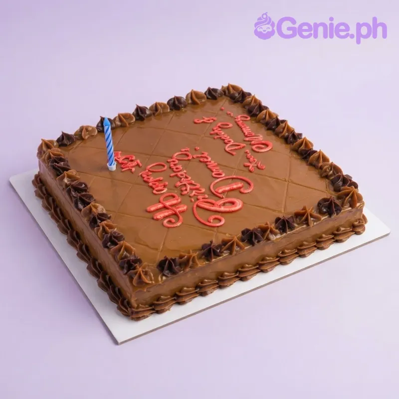 Brown rectangle sheet cake with smooth soft icing, brown piped icing star borders, and a blue and white striped birthday candle Brown rectangle sheet cake with smooth soft icing, brown piped icing star borders, and a blue and white striped birthday candle