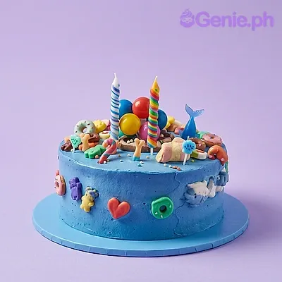 Blue 1-tier birthday cake with candles, a small whale toy, and colorful decorative balls Blue 1-tier birthday cake with candles, a small whale toy, and colorful decorative balls