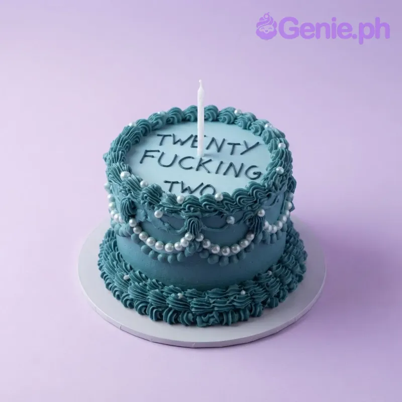 Teal 1-tier birthday cake with soft icing, piped borders, a white candle, and dark red piped text on top Teal 1-tier birthday cake with soft icing, piped borders, a white candle, and dark red piped text on top