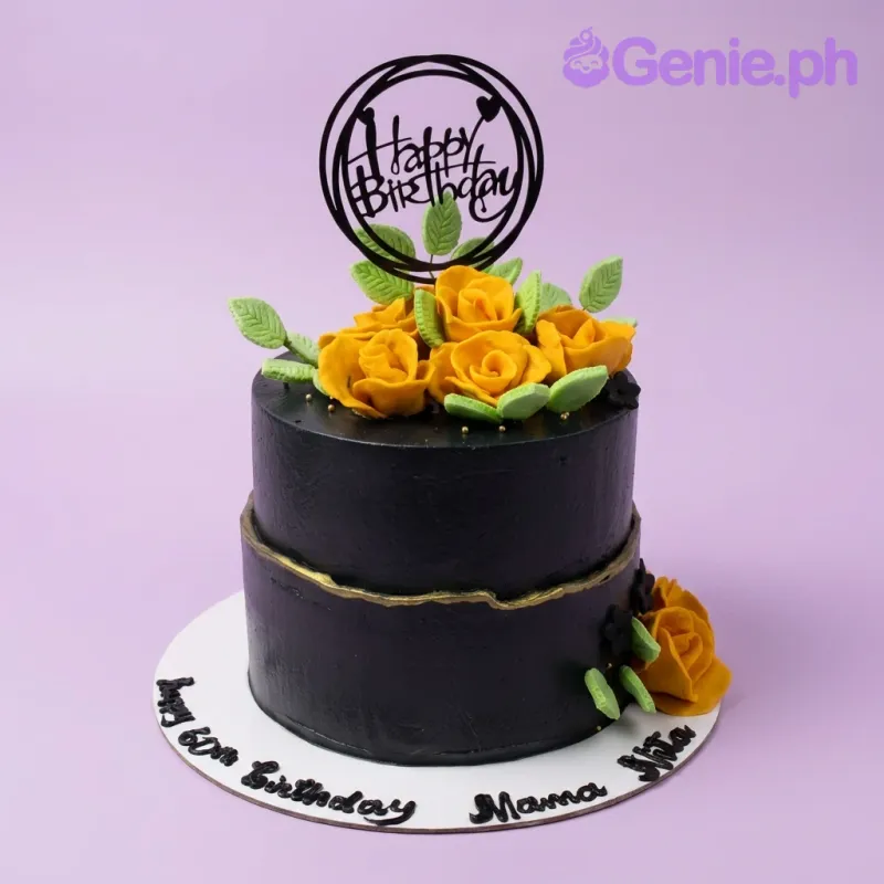 A black two-tier cake with yellow gumpaste roses, green leaves, gold crack line, and a black 'Happy Birthday' topper. A black two-tier cake with yellow gumpaste roses, green leaves, gold crack line, and a black 'Happy Birthday' topper.