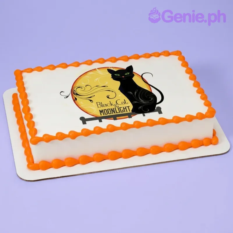 A white and orange Rectangle cake themed around Black Cat Moonlight, featuring a black cat and yellow moon printout and orange icing borders. A white and orange Rectangle cake themed around Black Cat Moonlight, featuring a black cat and yellow moon printout and orange icing borders.