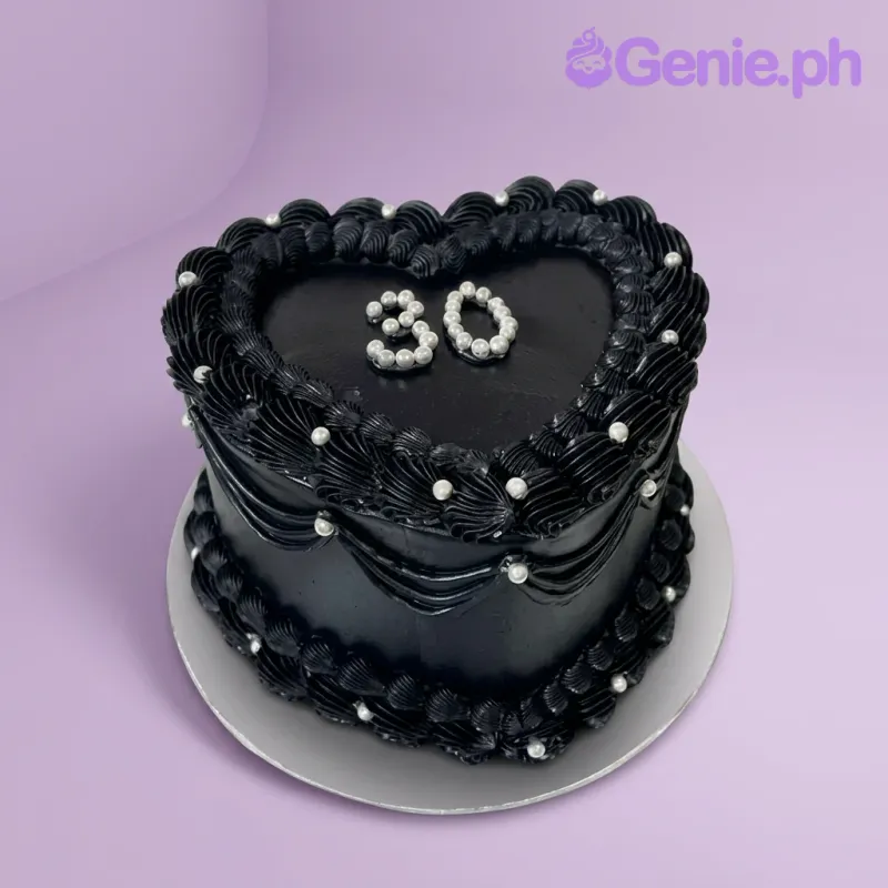 A black heart-shaped 1 Tier cake themed around Black Heart Vintage, featuring a silver '30' topper and intricate black piped ruffles with silver pearls.