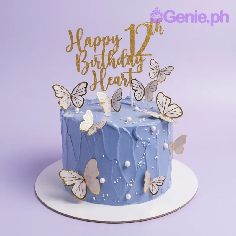 A blue 1-tier Blue Butterfly cake, featuring a gold 'Happy Birthday' topper, white butterflies, and pearl sprinkles. A blue 1-tier Blue Butterfly cake, featuring a gold 'Happy Birthday' topper, white butterflies, and pearl sprinkles.