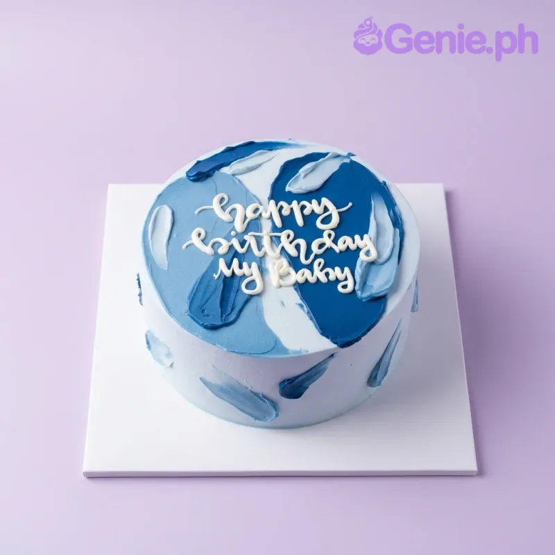 A light blue 1 Tier cake themed around Minimalist design, featuring dark blue palette knife icing strokes and a white piped message. A light blue 1 Tier cake themed around Minimalist design, featuring dark blue palette knife icing strokes and a white piped message.
