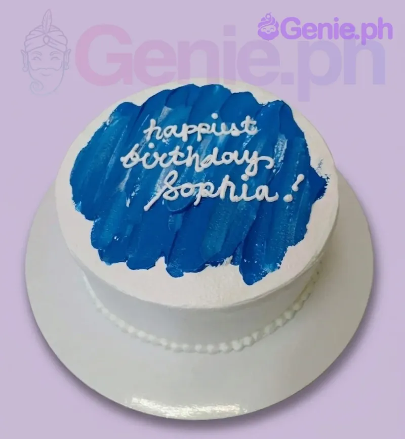 A white and blue 1-tier cake themed around minimalism, featuring a blue palette knife stroke and white piped text. A white and blue 1-tier cake themed around minimalism, featuring a blue palette knife stroke and white piped text.