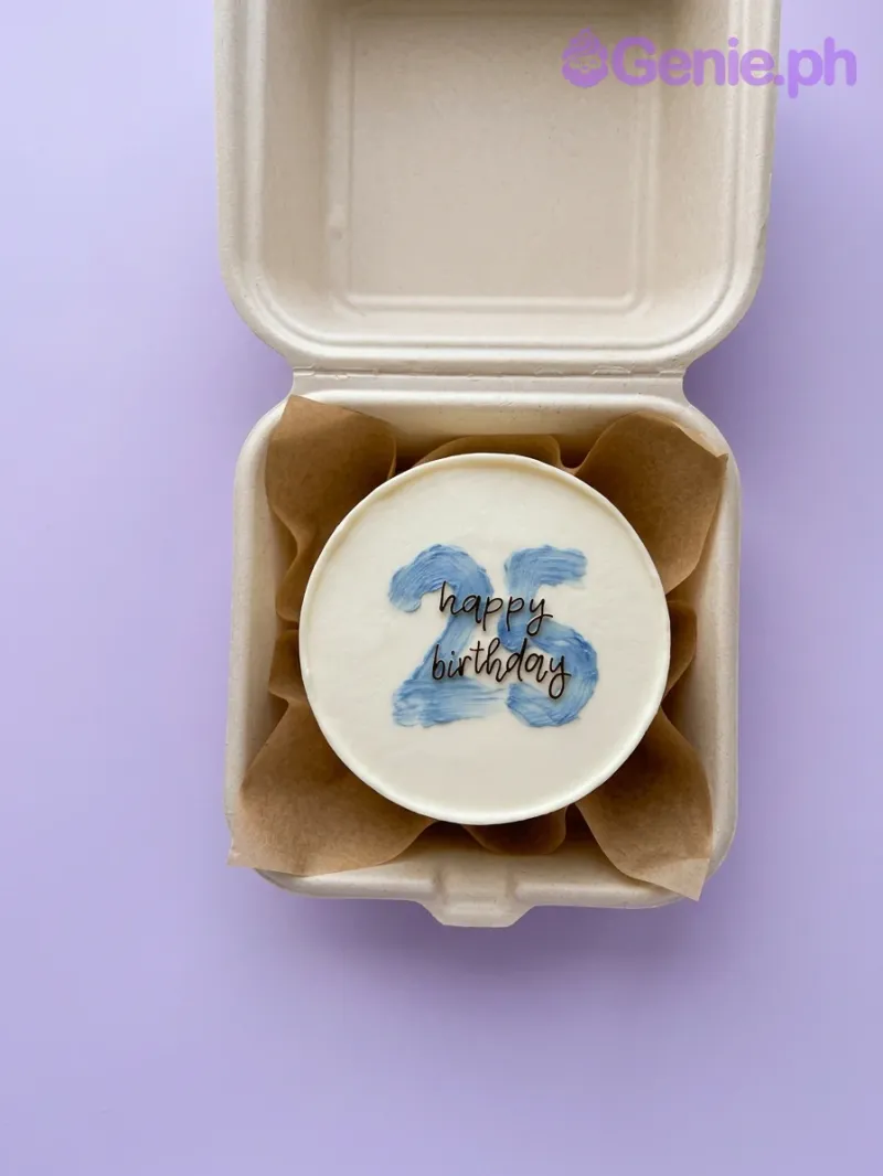 A white bento cake themed around Blue Minimalist 25th birthday, featuring a blue palette knife number 25 and black 'happy birthday' text. A white bento cake themed around Blue Minimalist 25th birthday, featuring a blue palette knife number 25 and black 'happy birthday' text.
