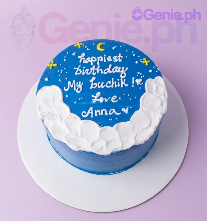 A blue 1-tier cake with white icing clouds, a yellow moon, yellow stars, and a birthday message. A blue 1-tier cake with white icing clouds, a yellow moon, yellow stars, and a birthday message.