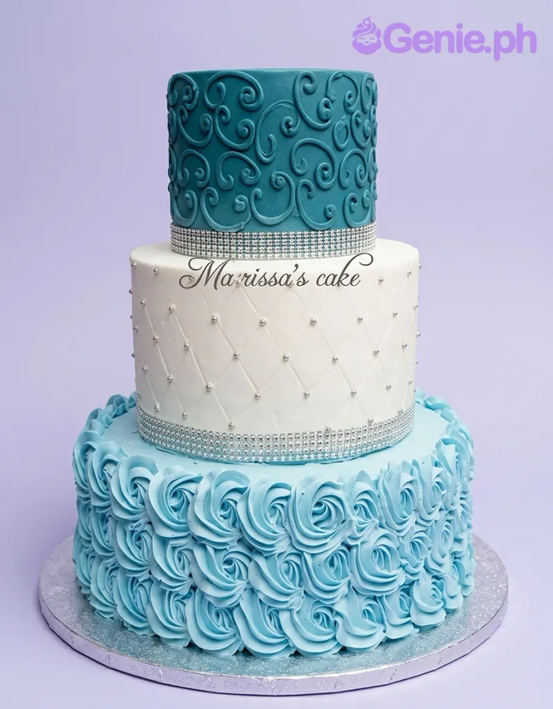 A blue and white three-tier cake themed around elegance, featuring intricate scrollwork, quilted patterns, and blue icing rosettes. A blue and white three-tier cake themed around elegance, featuring intricate scrollwork, quilted patterns, and blue icing rosettes.