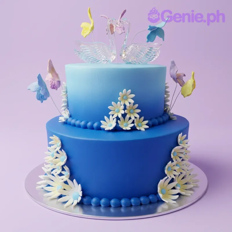 A blue gradient two-tier fondant cake, featuring a glass swan topper, colorful butterfly cutouts, and white daisies. A blue gradient two-tier fondant cake, featuring a glass swan topper, colorful butterfly cutouts, and white daisies.