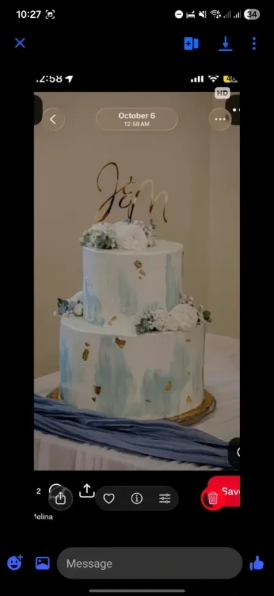 White 2-tier wedding cake with smooth soft icing, blue watercolor details, and edible white flower clusters White 2-tier wedding cake with smooth soft icing, blue watercolor details, and edible white flower clusters