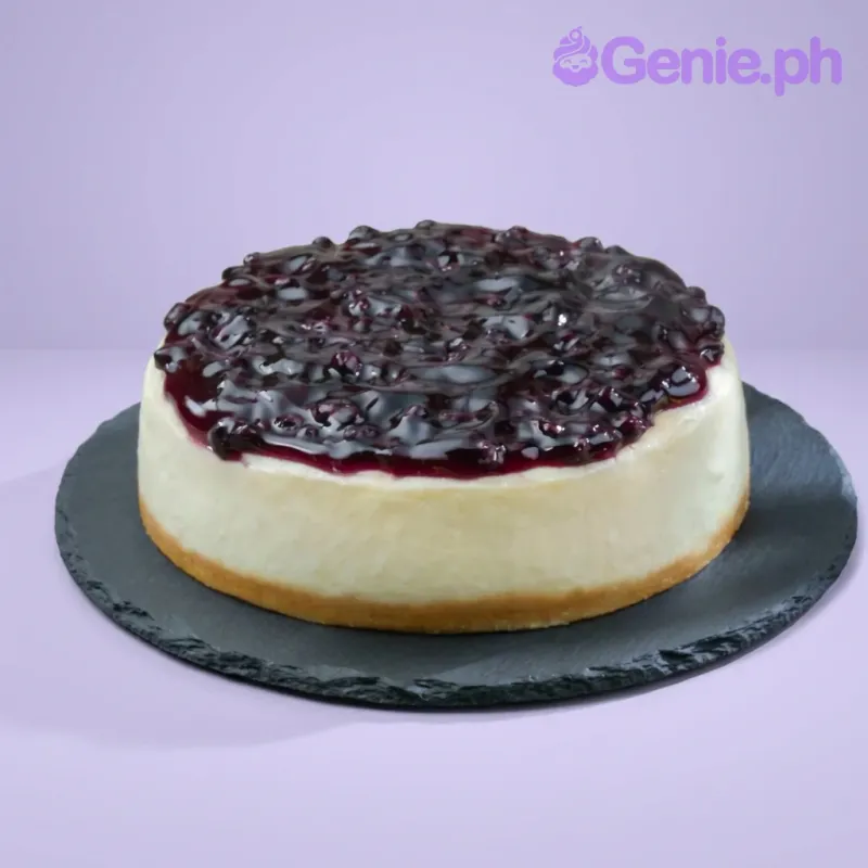 A white and blue 1 Tier Round cake themed around Blueberry Cheesecake, featuring a thick blueberry compote and a graham cracker crust. A white and blue 1 Tier Round cake themed around Blueberry Cheesecake, featuring a thick blueberry compote and a graham cracker crust.