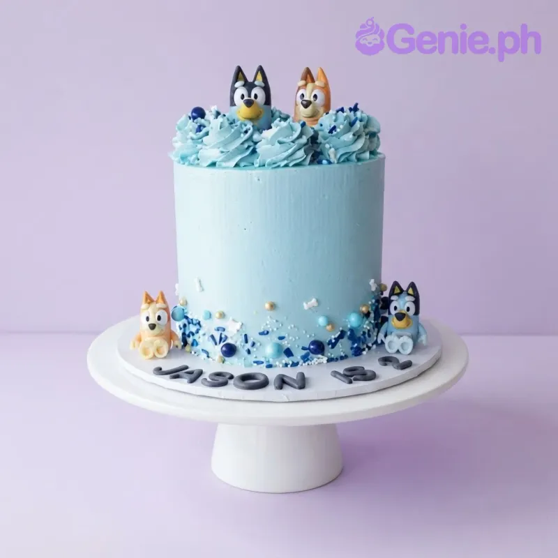 Light blue 1-tier cake with Bluey and Bingo toy toppers, piped icing swirls, and blue sprinkle accents Light blue 1-tier cake with Bluey and Bingo toy toppers, piped icing swirls, and blue sprinkle accents