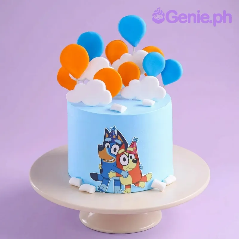 A light blue 1 Tier cake themed around Bluey, featuring Bluey and Bingo, blue and orange balloons, and white clouds. A light blue 1 Tier cake themed around Bluey, featuring Bluey and Bingo, blue and orange balloons, and white clouds.