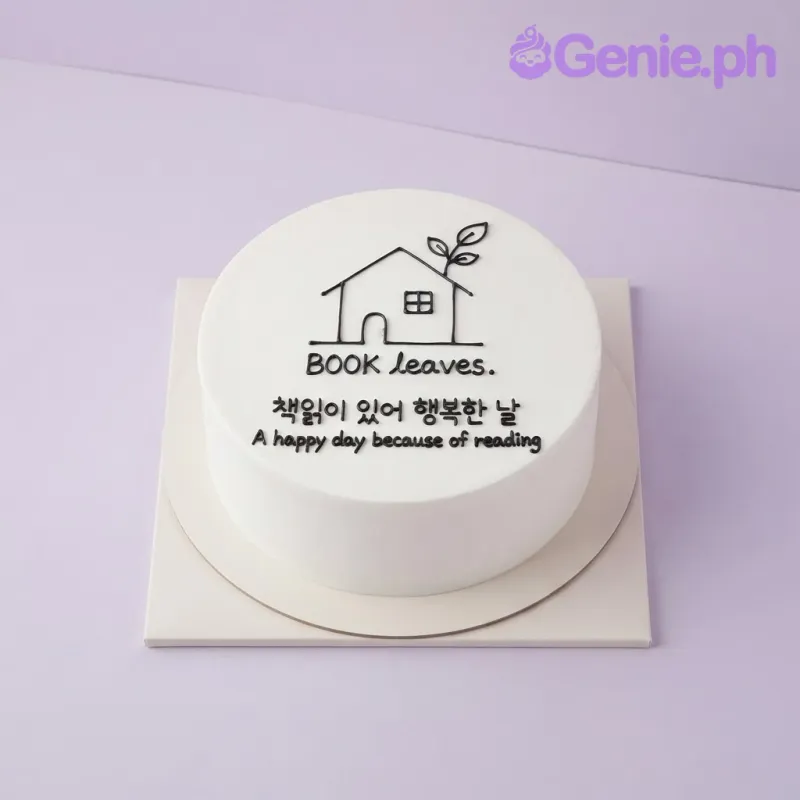White 1-tier cake with a black icing doodle of a house and book, featuring the text Book leaves. White 1-tier cake with a black icing doodle of a house and book, featuring the text Book leaves.