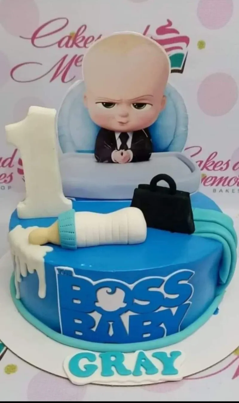 Boss Baby themed blue fondant cake with a 3D baby figure, milk bottle, and briefcase toppers for a first birthday. Boss Baby themed blue fondant cake with a 3D baby figure, milk bottle, and briefcase toppers for a first birthday.