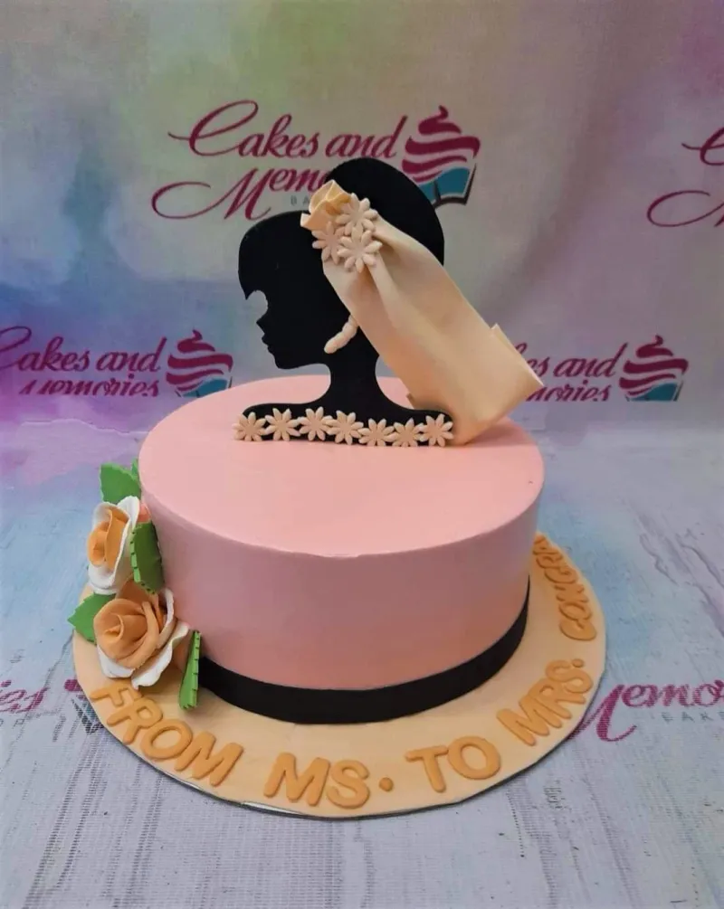 Pink minimalist bridal shower cake with a black silhouette bride topper wearing a cream veil and orange fondant roses. Pink minimalist bridal shower cake with a black silhouette bride topper wearing a cream veil and orange fondant roses.
