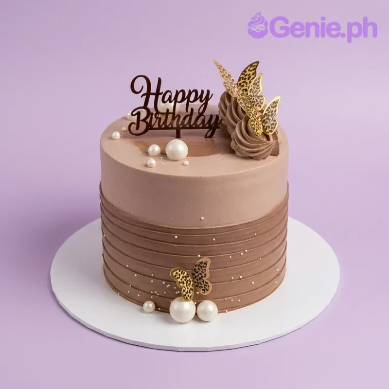 Brown 1-tier birthday cake with leopard print butterflies, white pearls, and chocolate icing swirls. Brown 1-tier birthday cake with leopard print butterflies, white pearls, and chocolate icing swirls.