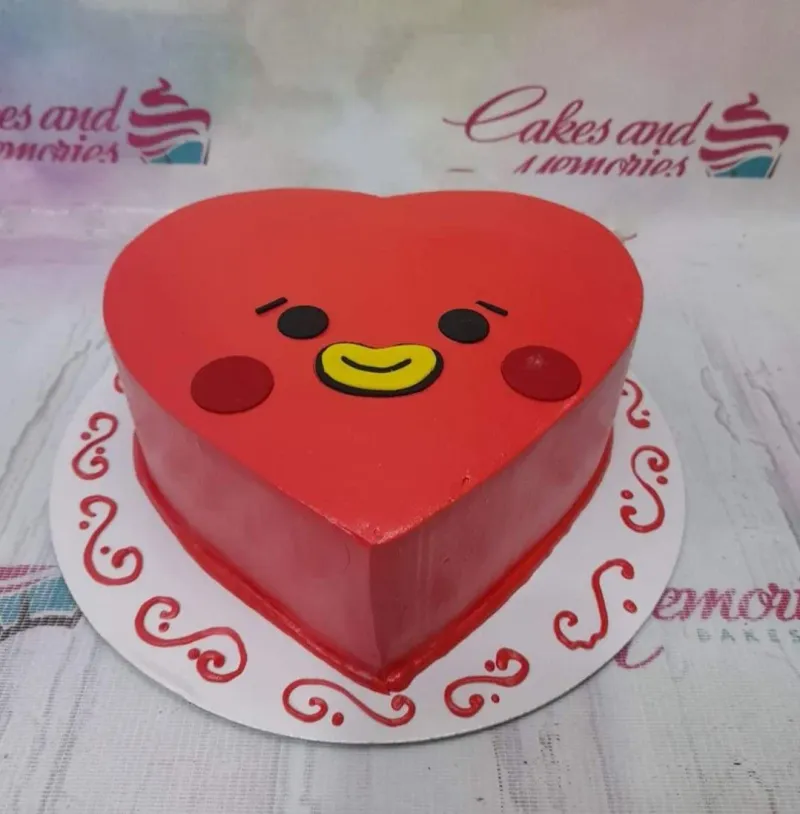 A red, white, and yellow heart-shaped cake themed BT21 Tata, featuring Tata's character face and red icing swirls. A red, white, and yellow heart-shaped cake themed BT21 Tata, featuring Tata's character face and red icing swirls.