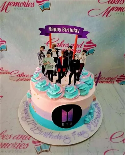 Pink and blue BTS themed birthday cake with character printouts and a purple banner topper. Pink and blue BTS themed birthday cake with character printouts and a purple banner topper.