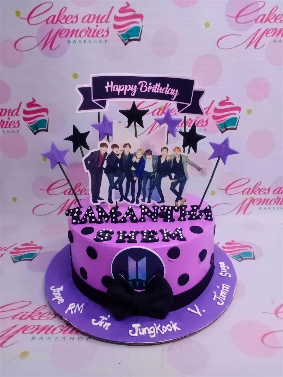 Purple BTS themed birthday cake with group photo printout, black polka dots, and a black fondant bow. Purple BTS themed birthday cake with group photo printout, black polka dots, and a black fondant bow.