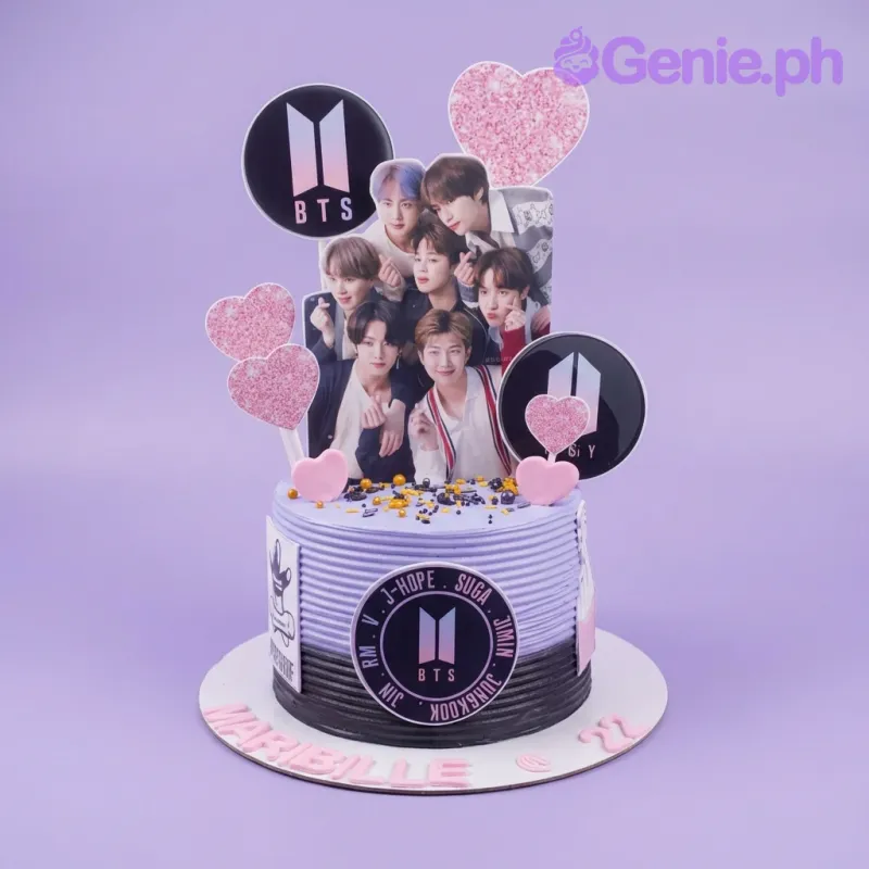 Purple BTS themed birthday cake with group photo printout, logo toppers, pink glitter hearts, and black and gold sprinkles. Purple BTS themed birthday cake with group photo printout, logo toppers, pink glitter hearts, and black and gold sprinkles.