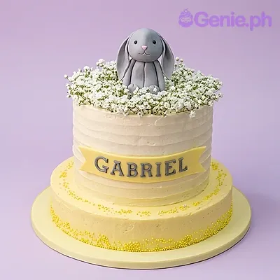 Light yellow 1-tier cake with a grey fondant bunny topper and baby's breath flowers Light yellow 1-tier cake with a grey fondant bunny topper and baby's breath flowers
