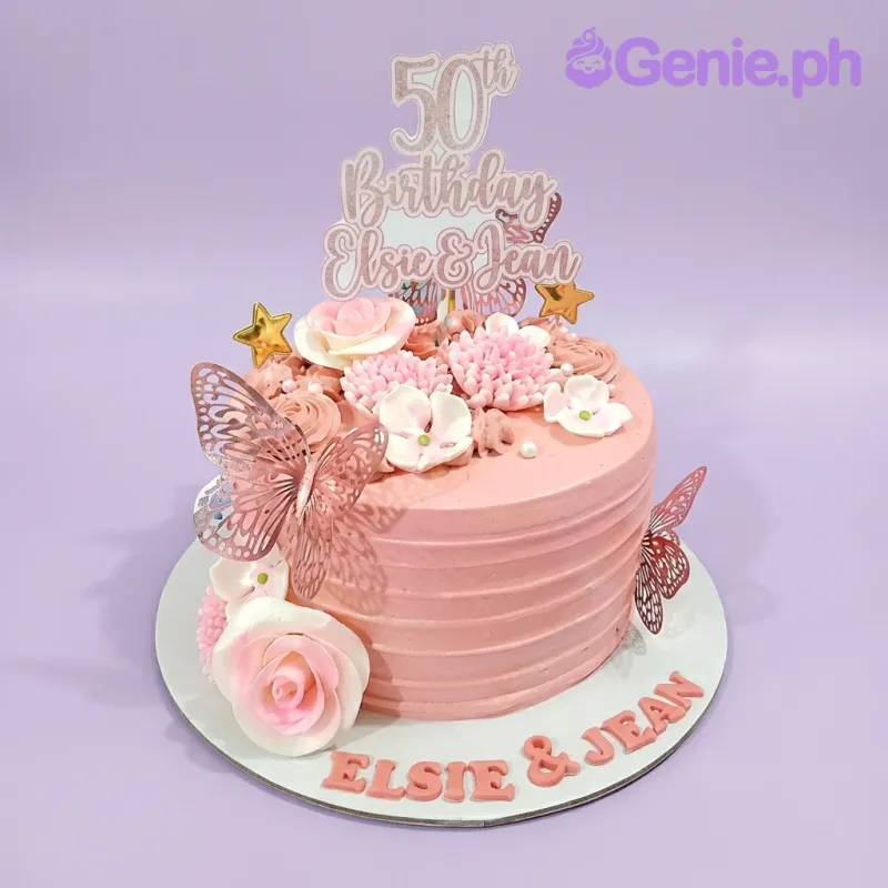 Pink 50th birthday cake with rose gold butterflies, pink and white edible flowers, and a glittery 50th birthday topper. Pink 50th birthday cake with rose gold butterflies, pink and white edible flowers, and a glittery 50th birthday topper.