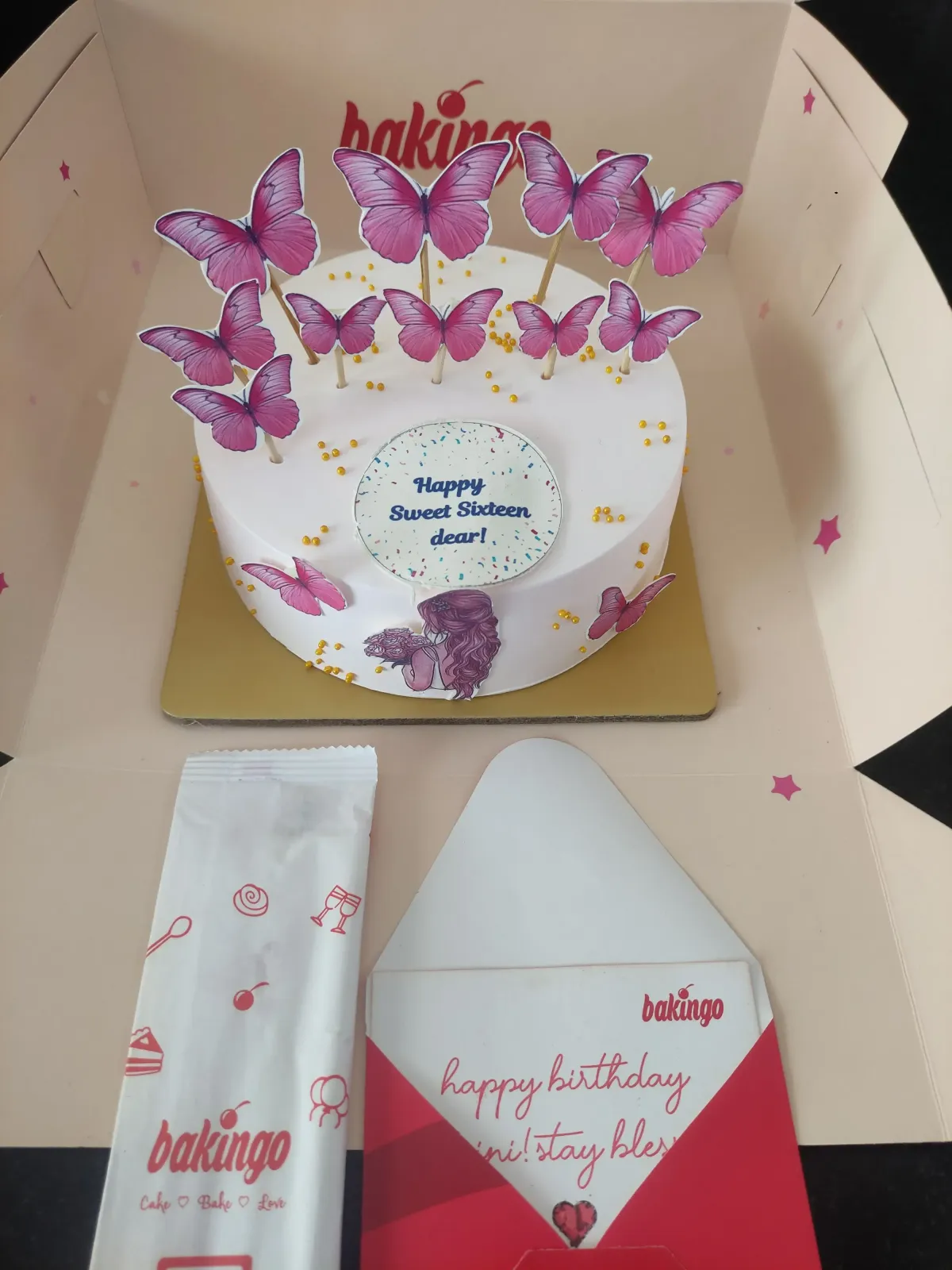 White bento cake with pink butterfly printouts and a Happy Sweet Sixteen message White bento cake with pink butterfly printouts and a Happy Sweet Sixteen message