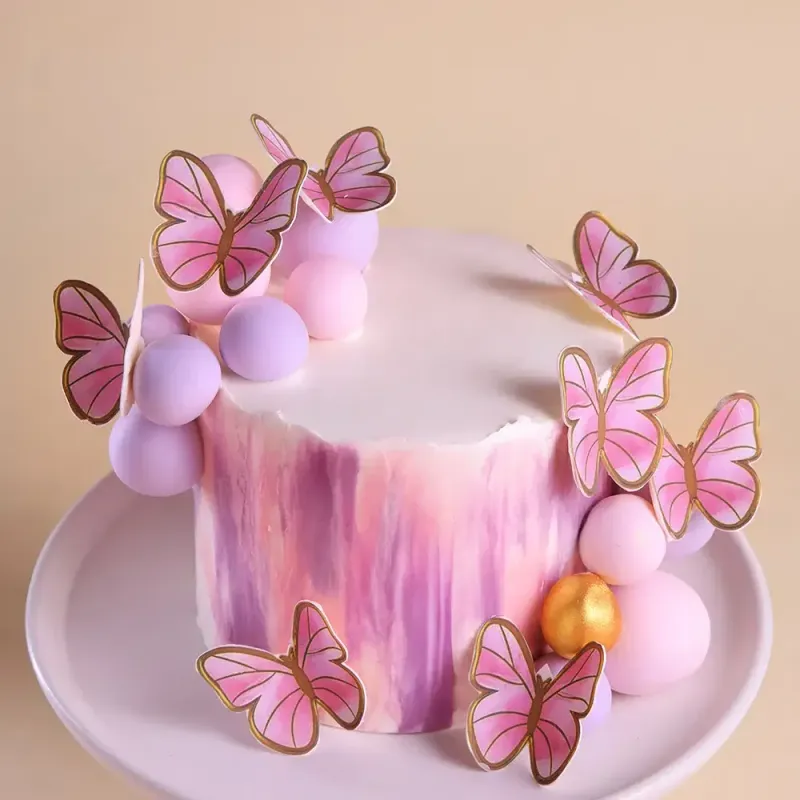 Pink and purple watercolor 1-tier cake with pink butterfly cutouts and pastel spheres Pink and purple watercolor 1-tier cake with pink butterfly cutouts and pastel spheres
