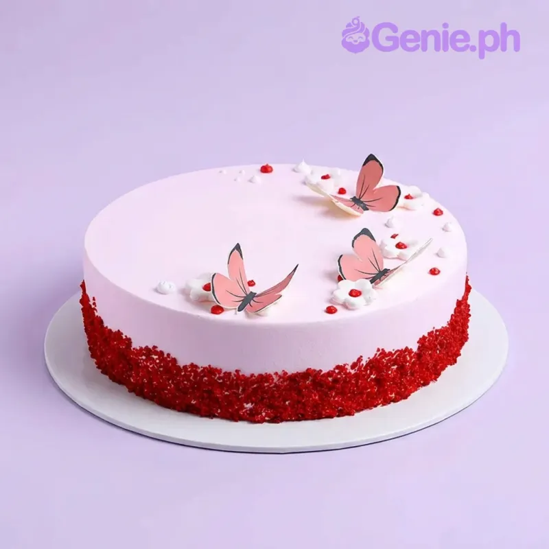 Light pink single-tier cake with butterfly printouts and red cake crumb border Light pink single-tier cake with butterfly printouts and red cake crumb border