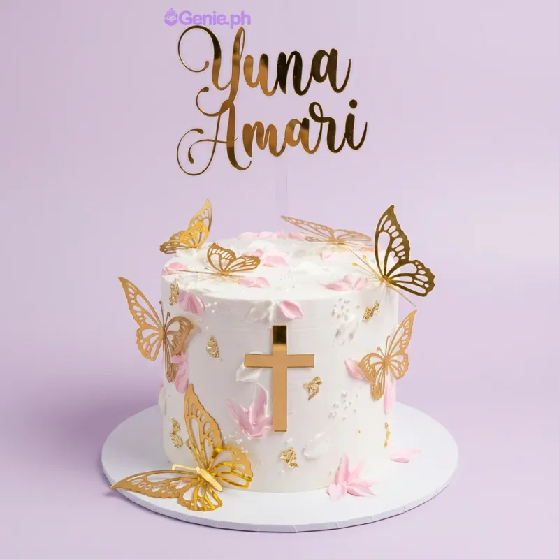 A white, gold, and pink 1-tier cake themed Butterfly Christening, featuring a gold name topper, cross, and butterflies. A white, gold, and pink 1-tier cake themed Butterfly Christening, featuring a gold name topper, cross, and butterflies.