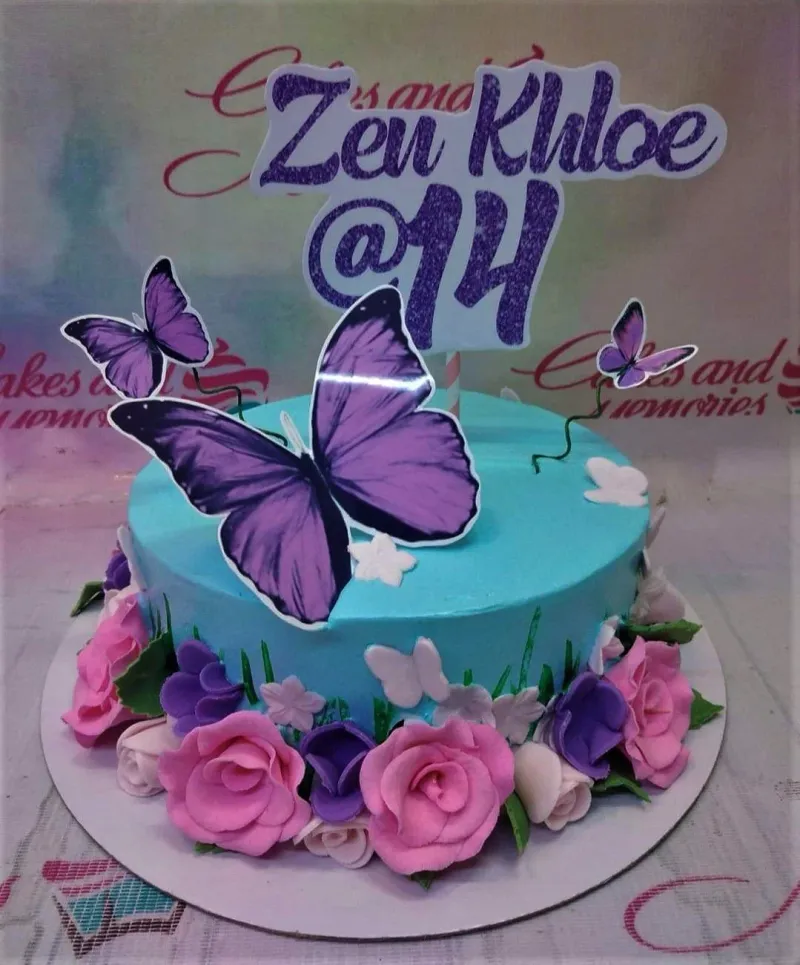 Light blue 1-tier birthday cake for Zen Khloe's 14th birthday featuring purple butterflies and pink and purple fondant roses. Light blue 1-tier birthday cake for Zen Khloe's 14th birthday featuring purple butterflies and pink and purple fondant roses.