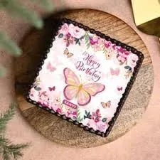 Square cake with edible print of flowers and butterfly on top and piped icing border Square cake with edible print of flowers and butterfly on top and piped icing border