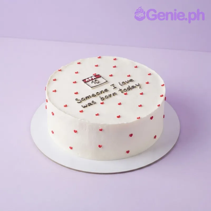 White minimalist single tier cake with piped red hearts and a calendar date printout White minimalist single tier cake with piped red hearts and a calendar date printout