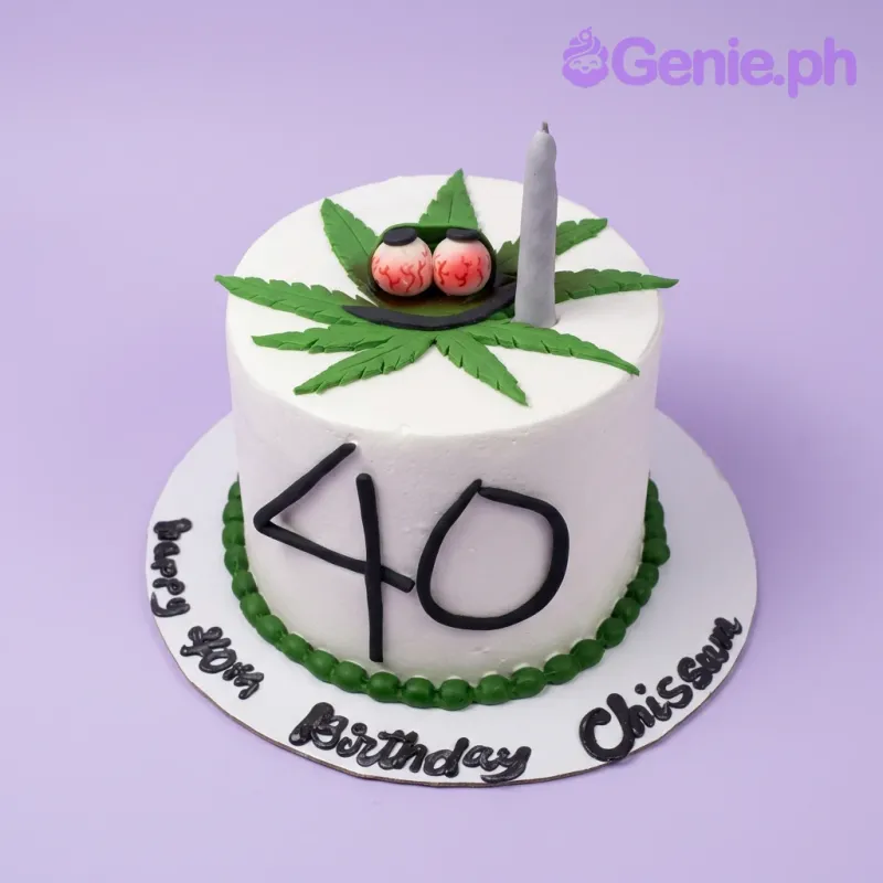 A white 1-tier cake themed for a Cannabis Birthday, featuring a green cannabis leaf with bloodshot eyes and a grey joint. A white 1-tier cake themed for a Cannabis Birthday, featuring a green cannabis leaf with bloodshot eyes and a grey joint.