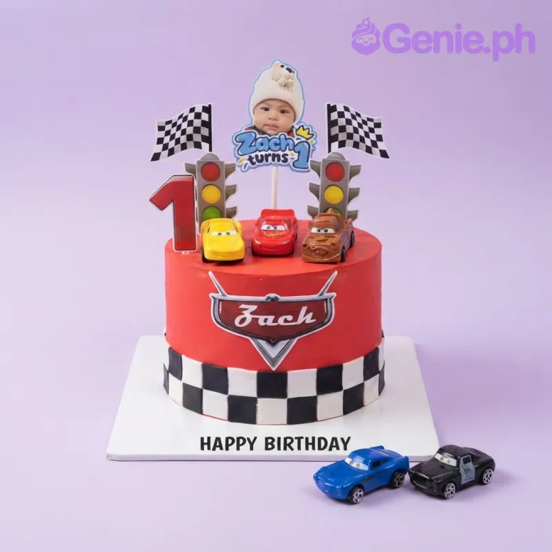 Vibrant red 1-tier birthday cake with smooth icing, a racing cars theme, and toy car toppers Vibrant red 1-tier birthday cake with smooth icing, a racing cars theme, and toy car toppers