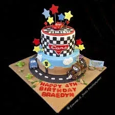 Blue and checkered 2-tier fondant birthday cake with Cars characters, stars, and road accents Blue and checkered 2-tier fondant birthday cake with Cars characters, stars, and road accents