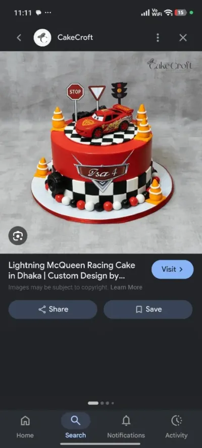Red fondant cake with a Lightning McQueen car topper, traffic signs, orange cones, and a checkered racing pattern Red fondant cake with a Lightning McQueen car topper, traffic signs, orange cones, and a checkered racing pattern