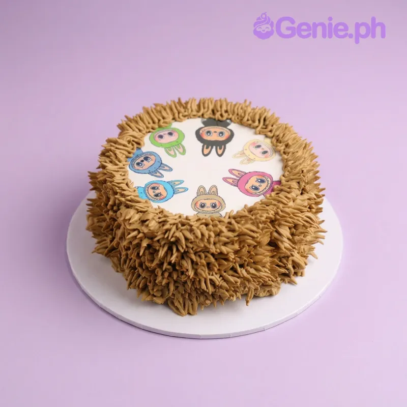One tier brown soft-iced cake with a circular printout of cartoon characters and piped brown icing texture One tier brown soft-iced cake with a circular printout of cartoon characters and piped brown icing texture