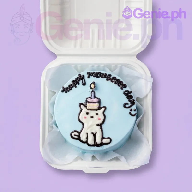 A light blue and white Bento cake themed around cats, featuring a hand-piped white cat illustration wearing a tiny piped cake and a black icing message. A light blue and white Bento cake themed around cats, featuring a hand-piped white cat illustration wearing a tiny piped cake and a black icing message.