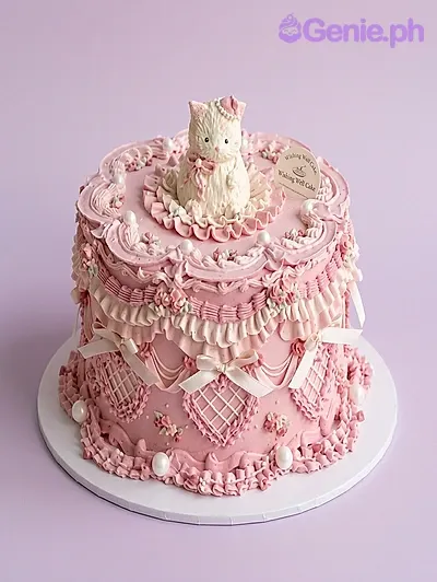 One tier cake with a cat figurine, a deer figurine, a tea set, and white pearls One tier cake with a cat figurine, a deer figurine, a tea set, and white pearls