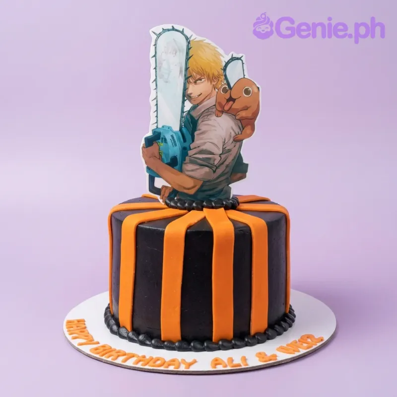 Black and orange Chainsaw Man themed cake with a large character printout and orange fondant stripes. Black and orange Chainsaw Man themed cake with a large character printout and orange fondant stripes.
