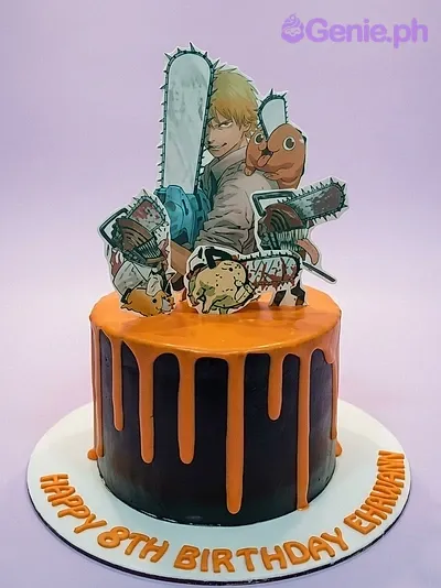 Black cake with orange drip and Chainsaw Man character printouts on top Black cake with orange drip and Chainsaw Man character printouts on top